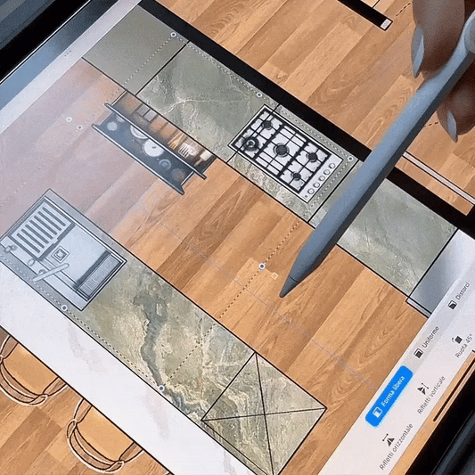 Design of a kitchen layout on a computer screen with a pen pointing at it.